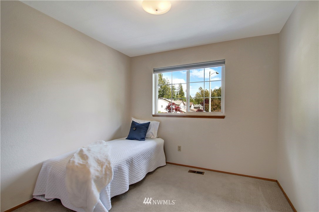 2126 164th Place Southeast Bothell, WA 98012 - Photo 14 of 18 a bedroom with a bed and a window