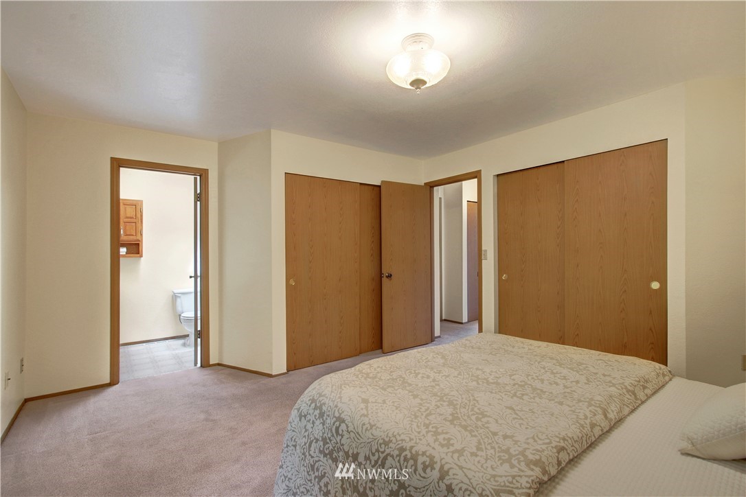 2126 164th Place Southeast Bothell, WA 98012 - Photo 10 of 18 a bedroom with a bed and a chandelier
