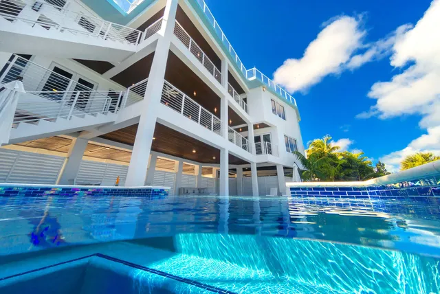 a large white kitchen with stainless steel appliances lots of counter top space