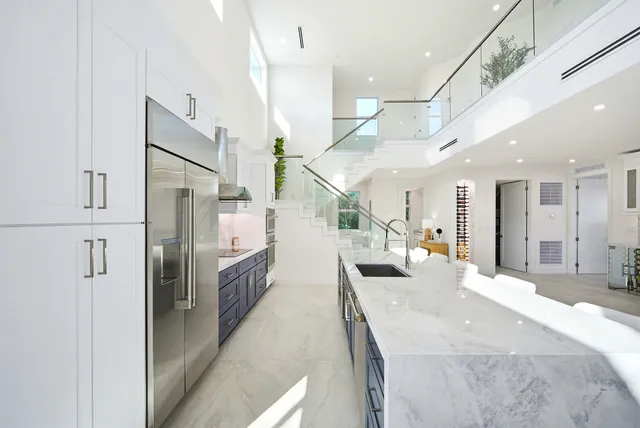 a spacious bedroom with a large bed and a chandelier