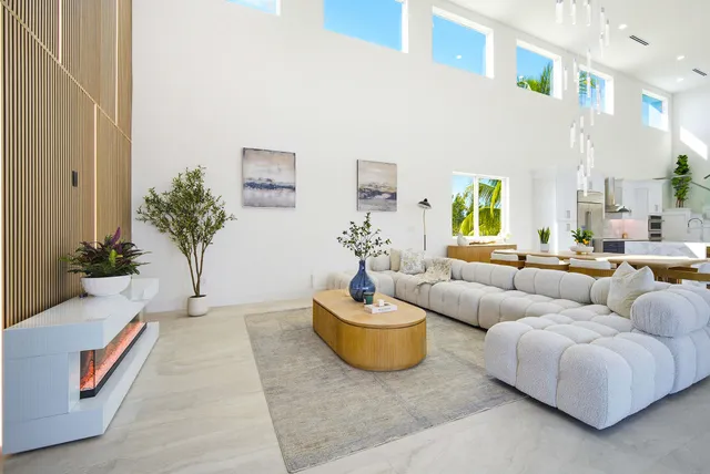 a swimming pool view with plants and large trees