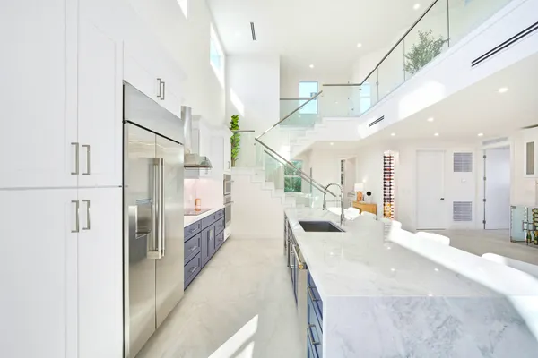 a kitchen with stainless steel appliances granite countertop a sink and a refrigerator