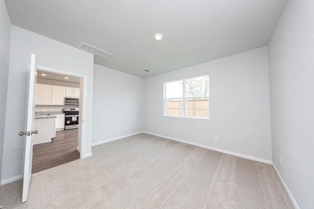 an empty room with windows and closet