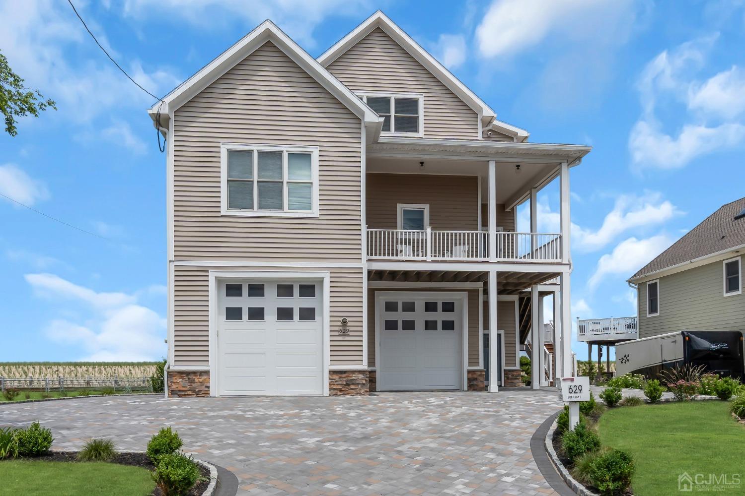629 Front Street Union Beach, NJ 07735 - Photo 1 of 63 a front view of a house with a garden