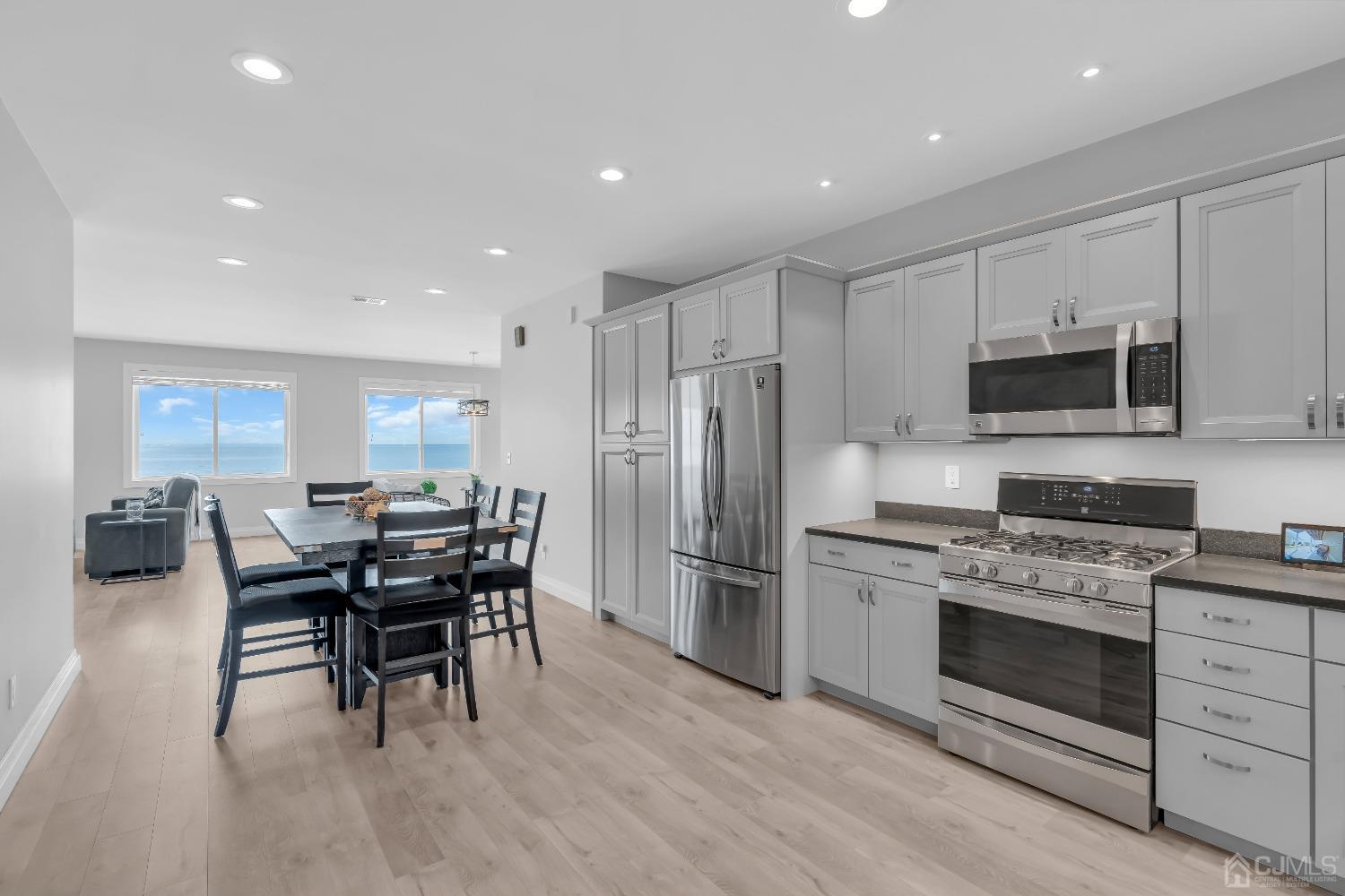 629 Front Street Union Beach, NJ 07735 - Photo 14 of 63 a kitchen with stainless steel appliances a stove a sink a oven a dining table and chairs