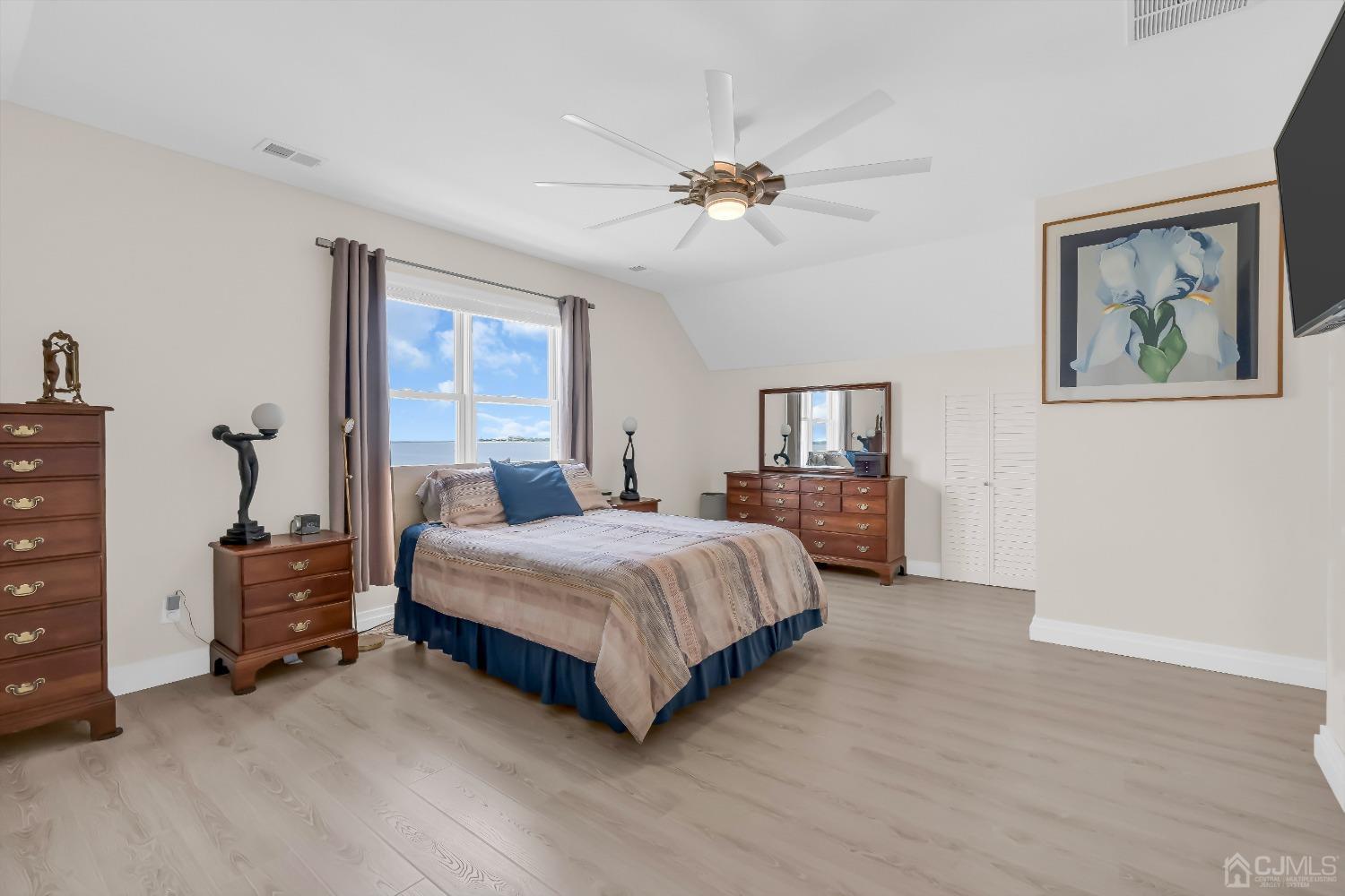629 Front Street Union Beach, NJ 07735 - Photo 21 of 63 a spacious bedroom with a bed and a chandelier