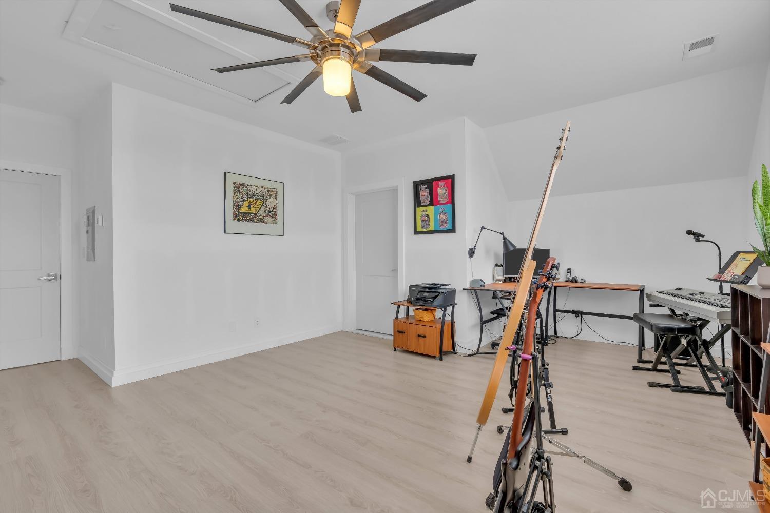 629 Front Street Union Beach, NJ 07735 - Photo 28 of 63 a view of a workspace with furniture and a ceiling fan