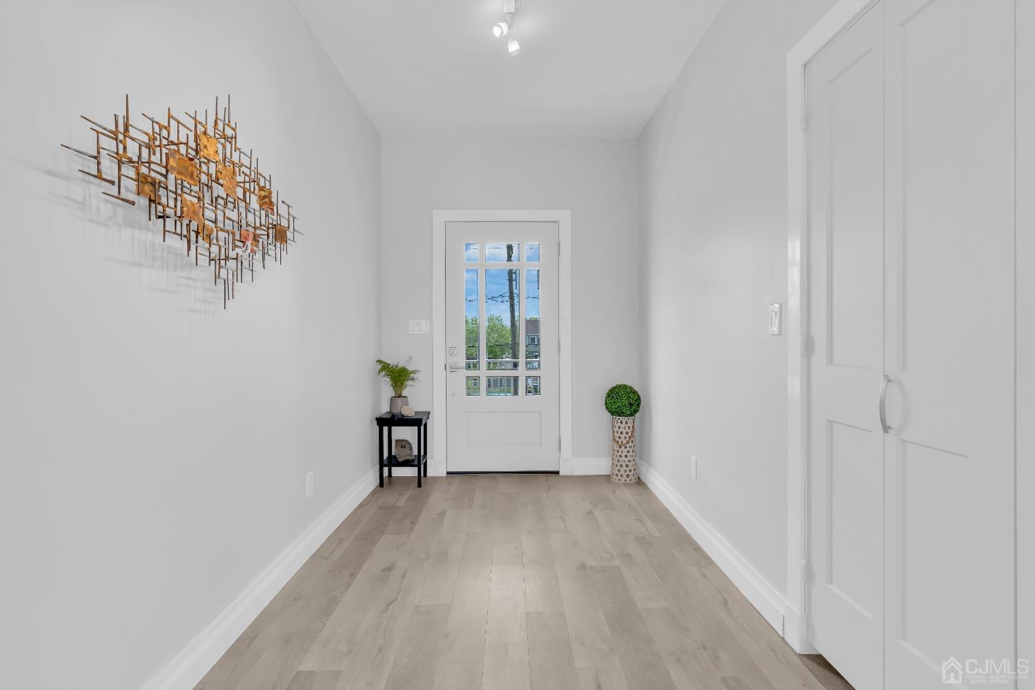 629 Front Street Union Beach, NJ 07735 - Photo 3 of 63 a view of empty room with wooden floor and fan