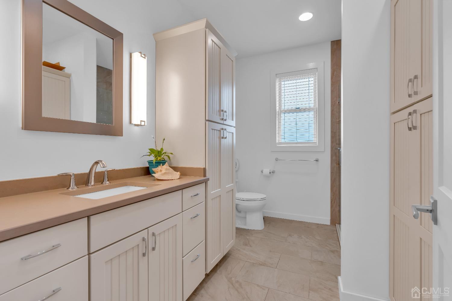 629 Front Street Union Beach, NJ 07735 - Photo 31 of 63 a bathroom with a granite countertop sink mirror and toilet