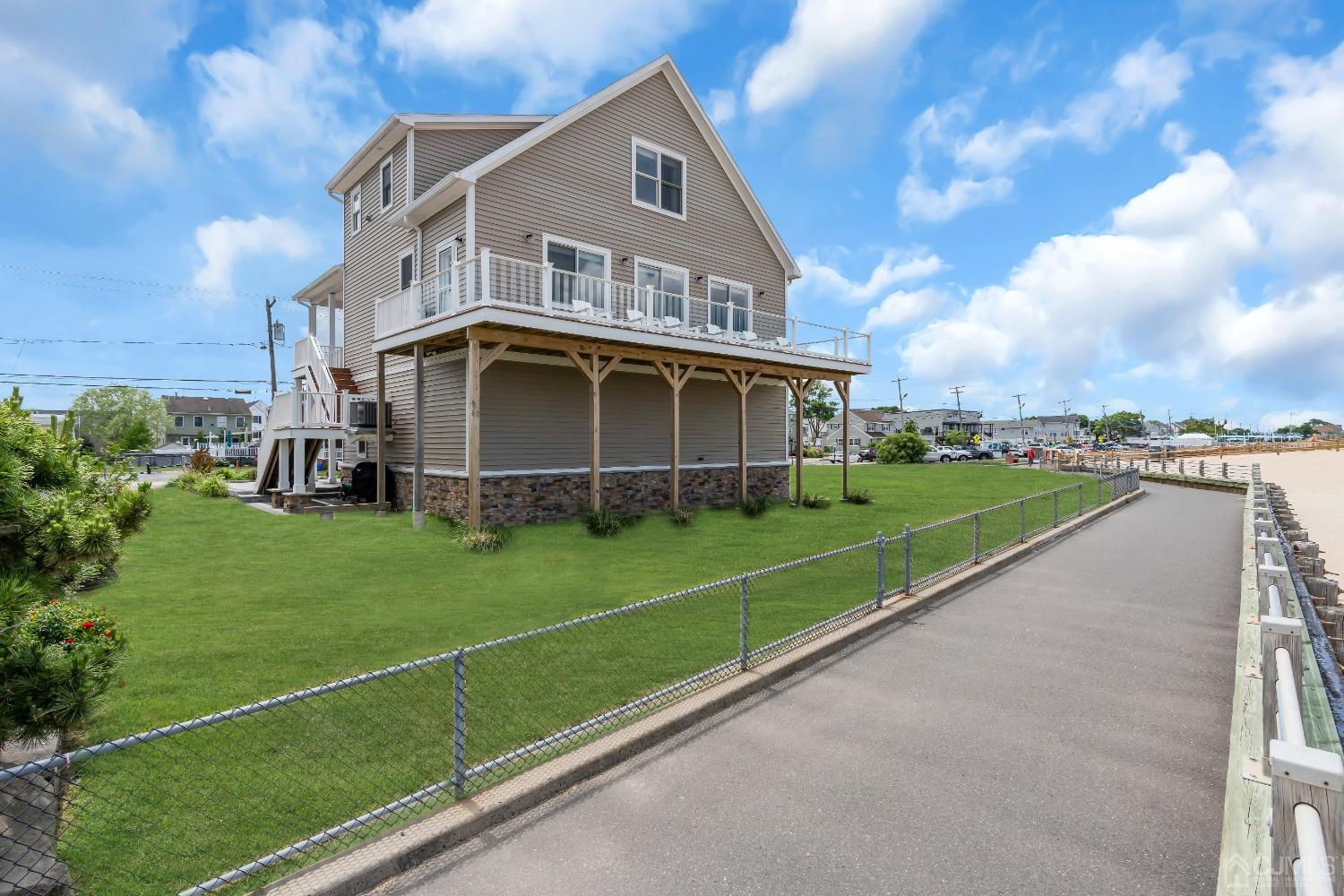 629 Front Street Union Beach, NJ 07735 - Photo 41 of 63 a view of a house with a big yard and potted plants