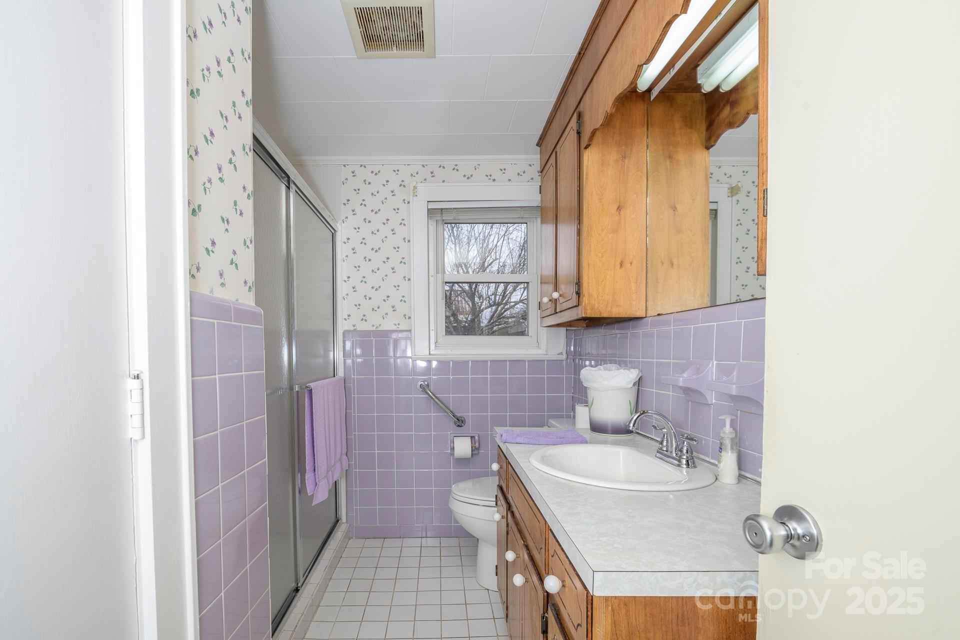 4267 Lower Cedar Valley Road Hudson, NC 28638 - Photo 27 of 45 a bathroom with a sink a toilet and shower