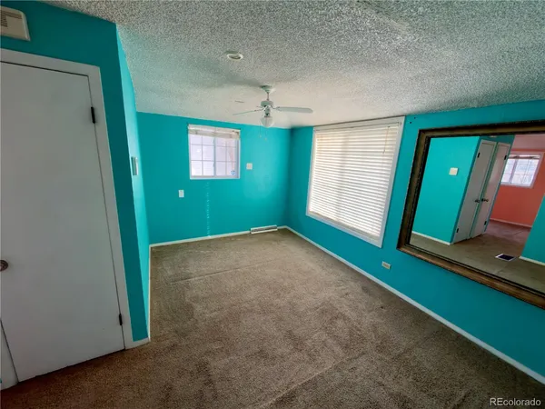 a view of an empty room with window and stairs