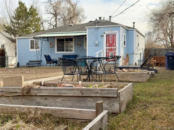 a front view of a house with outdoor seating