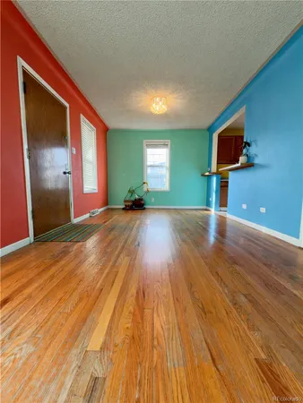 a view of a room with wooden floor and window