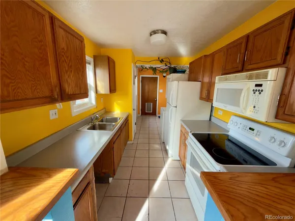a kitchen with stainless steel appliances a sink a stove and a refrigerator