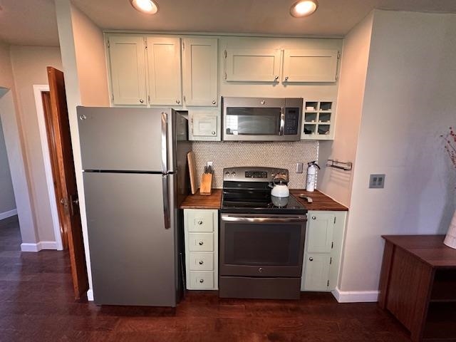 7 West Shagawa Road Ely, MN 55731 - Photo 3 of 32 Kitchen with stainless steel appliances, decorative backsplash, recessed lighting, dark wood-style flooring, and white cabinets