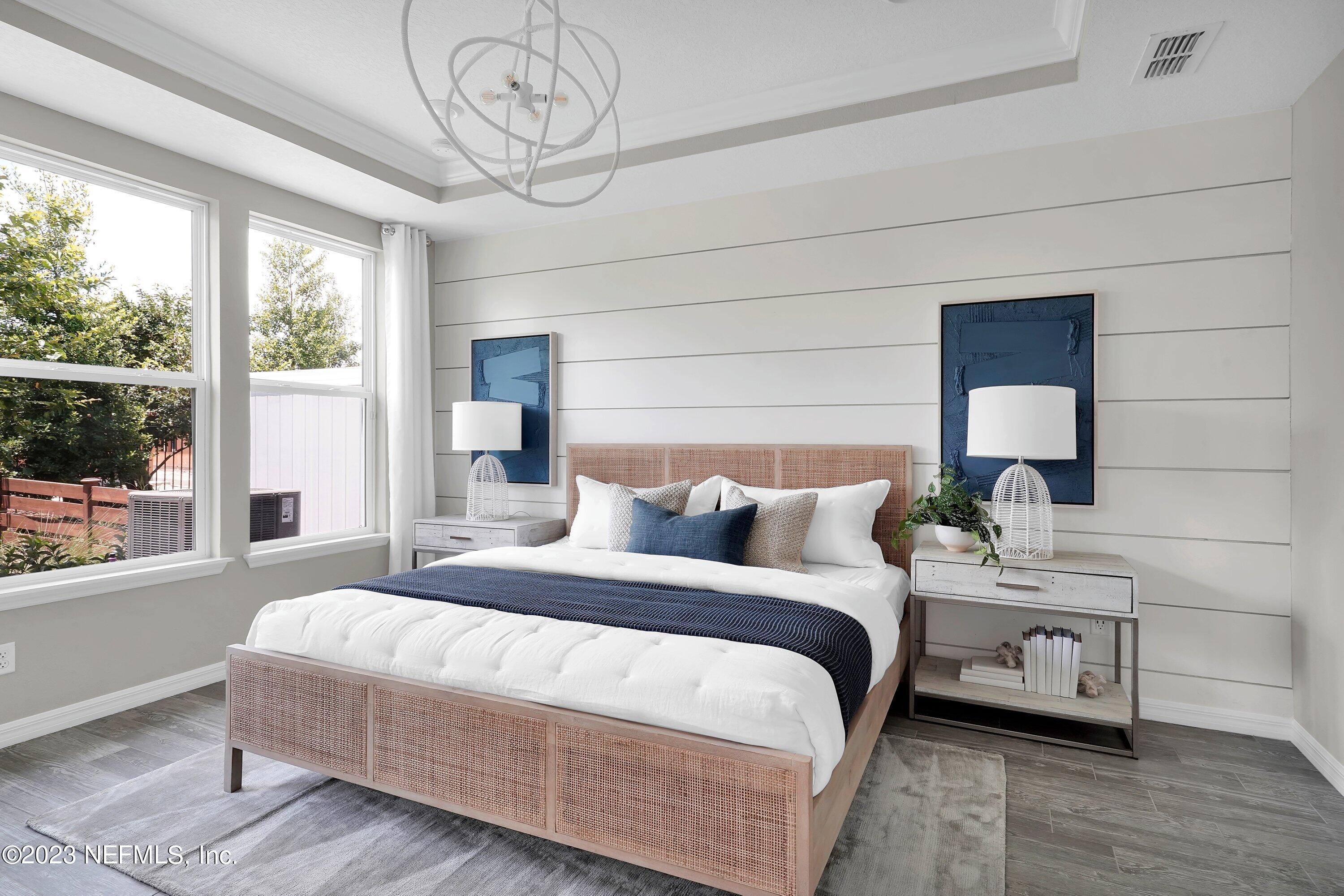 383 Jubilee Circle Yulee, FL 32097 - Photo 11 of 20 a bedroom with a bed a window and a chandelier