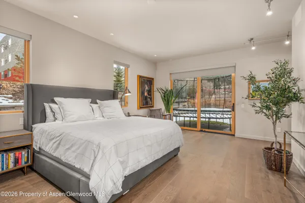 a spacious bedroom with a bed and a large window