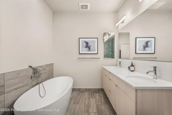 a bathroom with a double vanity sink mirror and toilet