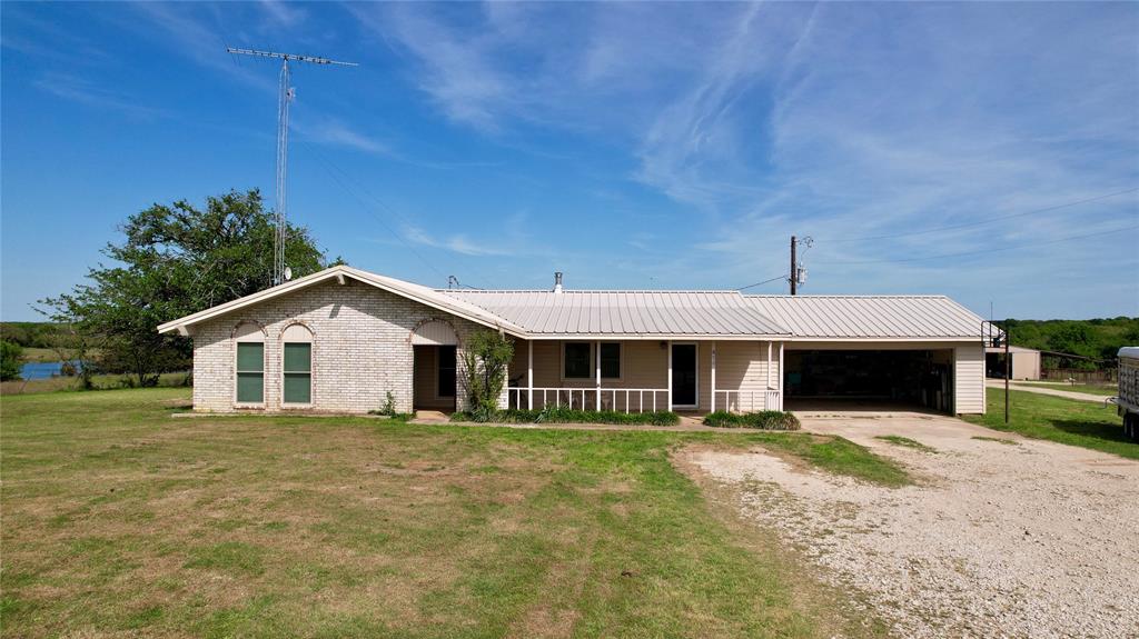 850 Gordonville Road Gordonville, TX 76245 - Photo 16 of 33 a front view of a house with a garden