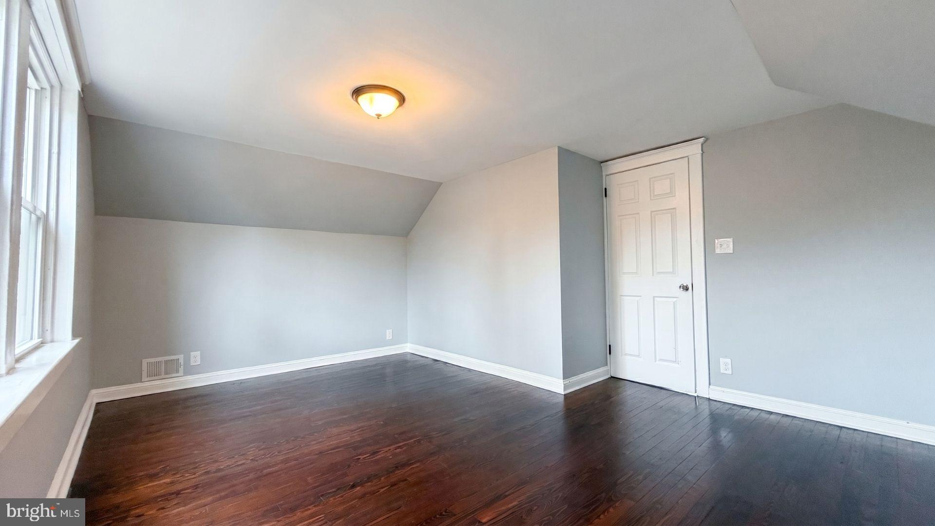 154 Andrew Street Hamilton, NJ 08610 - Photo 25 of 29 an empty room with wooden floor and windows