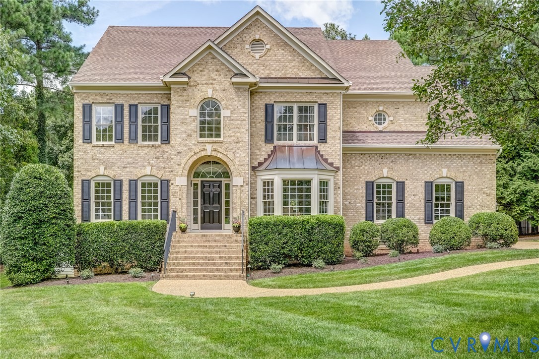 a front view of a house with a yard