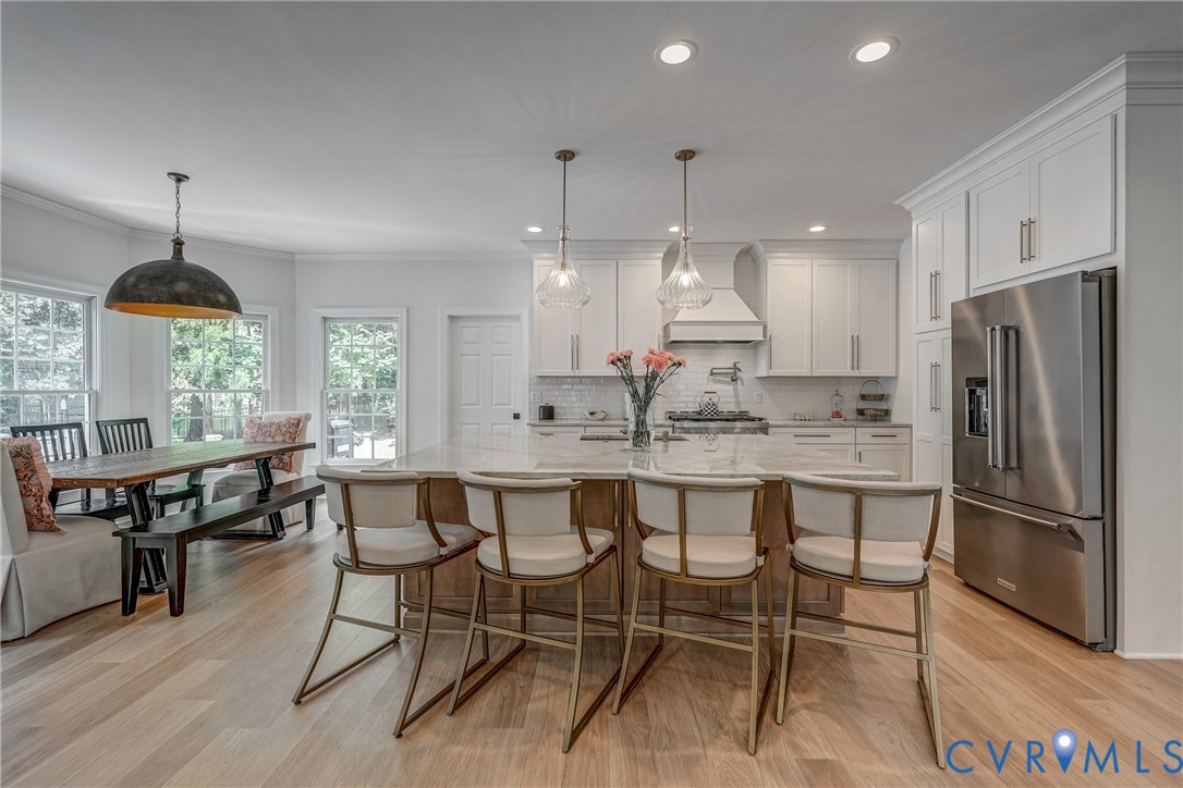 2306 Founders Bridge Road Midlothian, VA 23113 - Photo 16 of 50 a kitchen with stainless steel appliances granite countertop a table chairs stove a refrigerator and cabinets