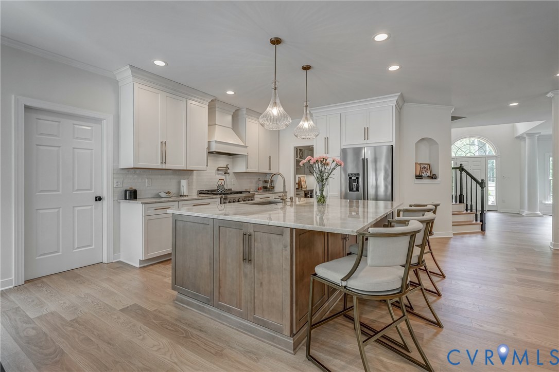 2306 Founders Bridge Road Midlothian, VA 23113 - Photo 23 of 50 a kitchen with kitchen island granite countertop a sink cabinets and wooden floor