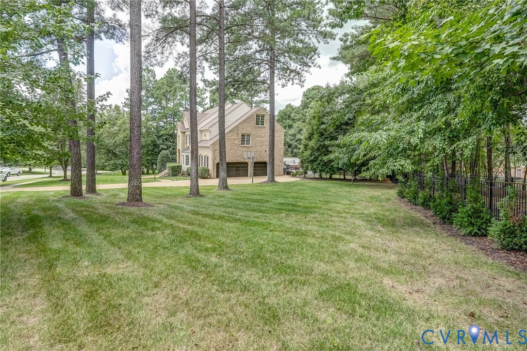 2306 Founders Bridge Road Midlothian, VA 23113 - Photo 3 of 50 a view of a trees in a yard with palm trees