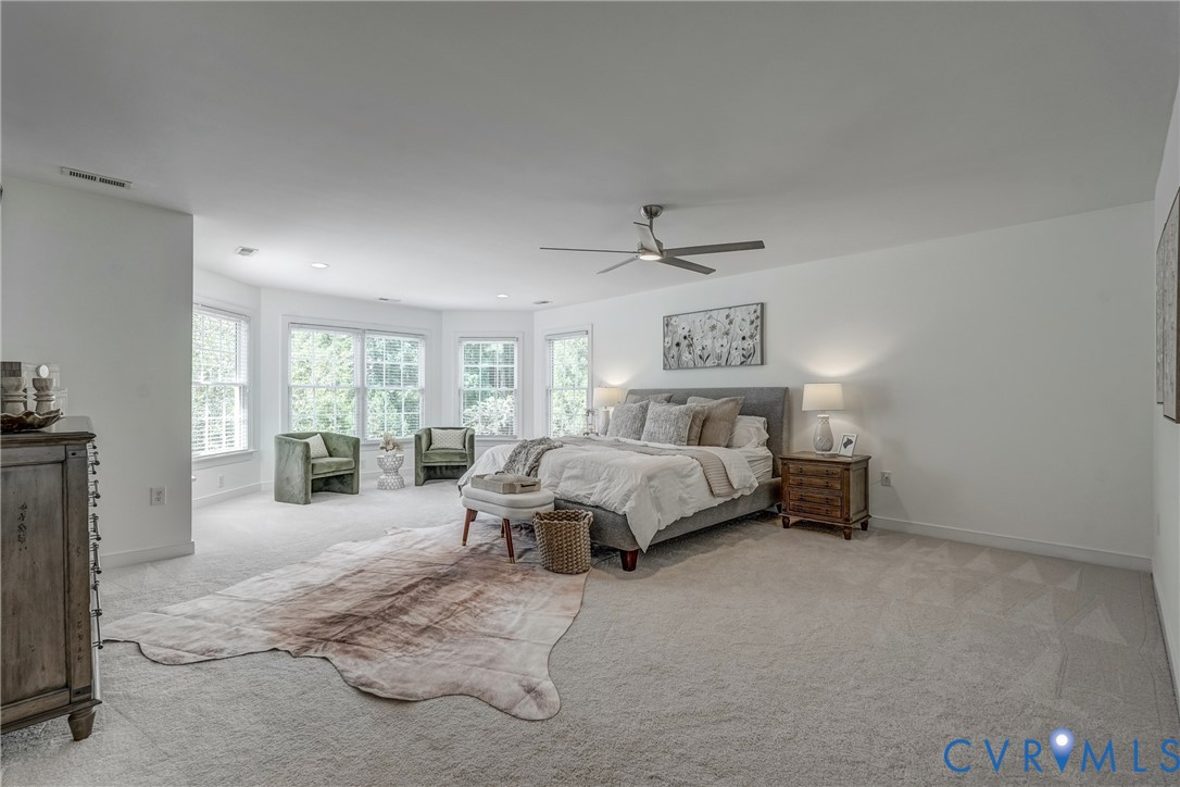 2306 Founders Bridge Road Midlothian, VA 23113 - Photo 31 of 50 a spacious bedroom with a bed a couch and large window