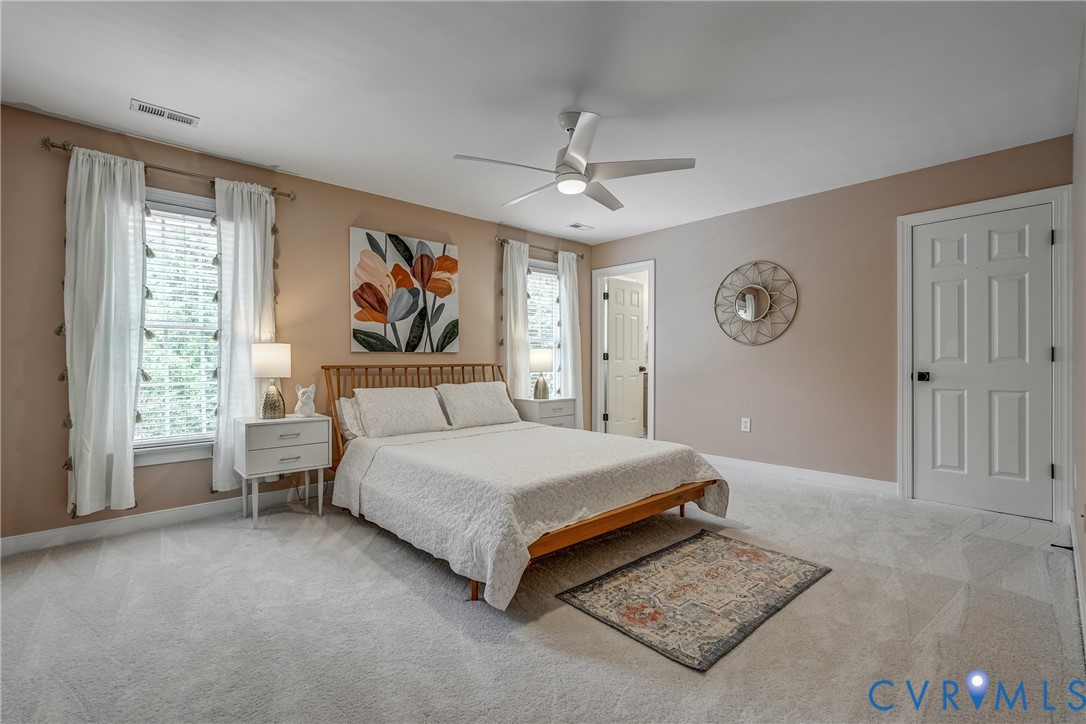 2306 Founders Bridge Road Midlothian, VA 23113 - Photo 36 of 50 a spacious bedroom with a large bed and a chandelier
