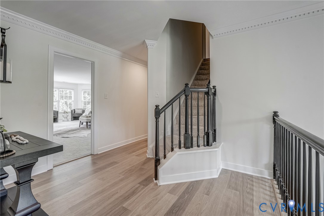 2306 Founders Bridge Road Midlothian, VA 23113 - Photo 39 of 50 a view of a hallway to a livingroom with wooden floor and furniture