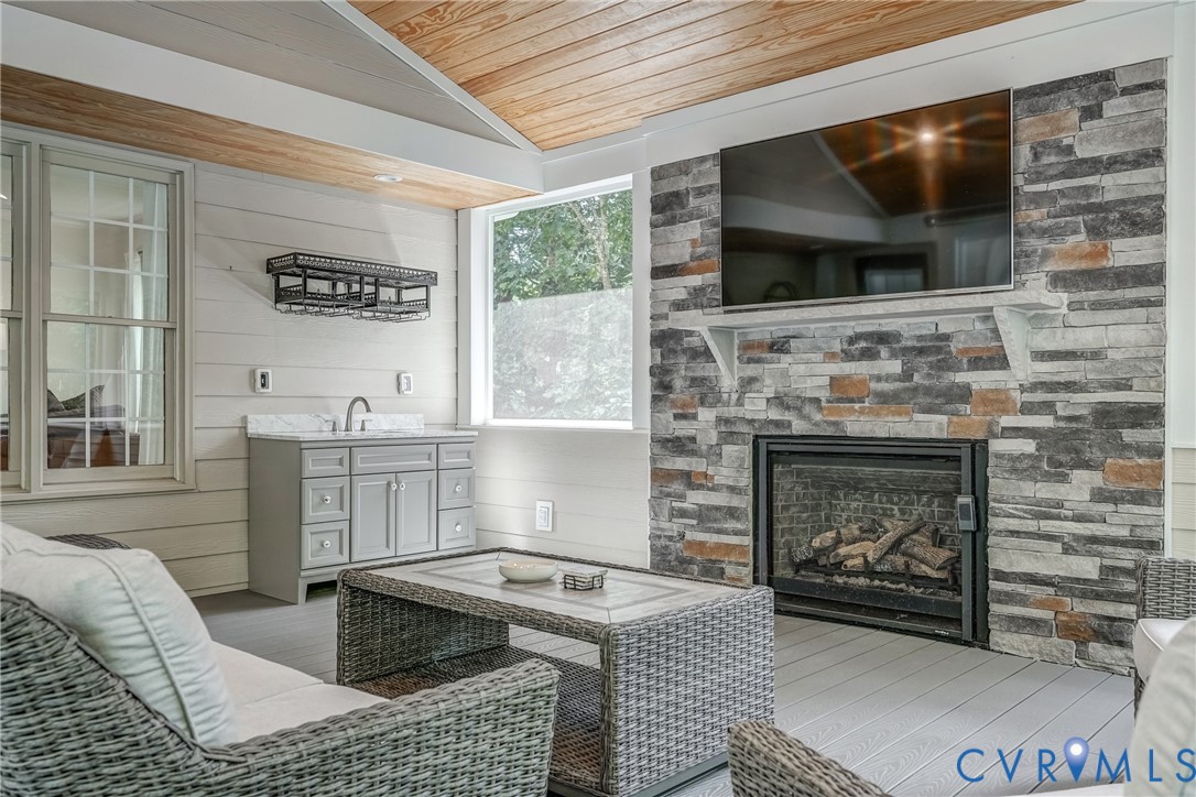 2306 Founders Bridge Road Midlothian, VA 23113 - Photo 42 of 50 a kitchen with furniture a flat screen tv and a fireplace