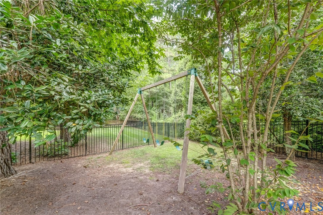 2306 Founders Bridge Road Midlothian, VA 23113 - Photo 46 of 50 a backyard of a house with plants and large trees