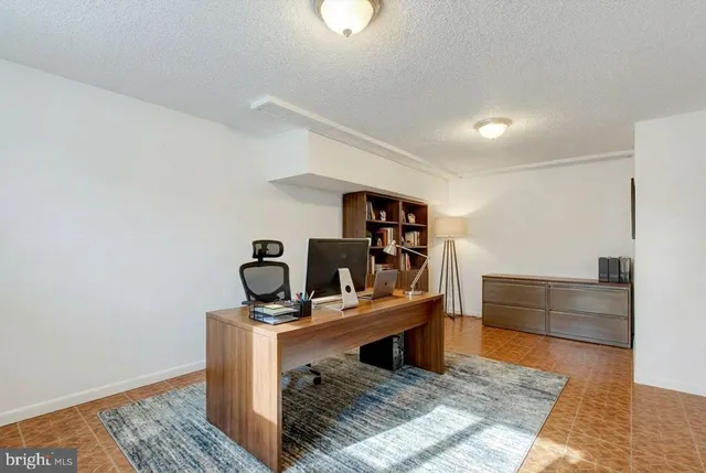 a living room with furniture and a book shelf