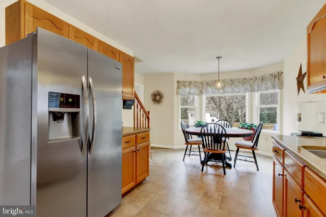 a dining room with furniture a chandelier and wooden floor