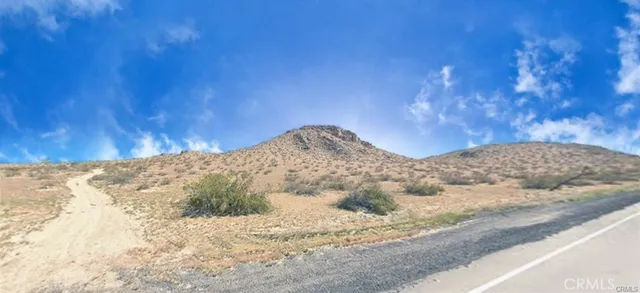a view of white house and snow on the road