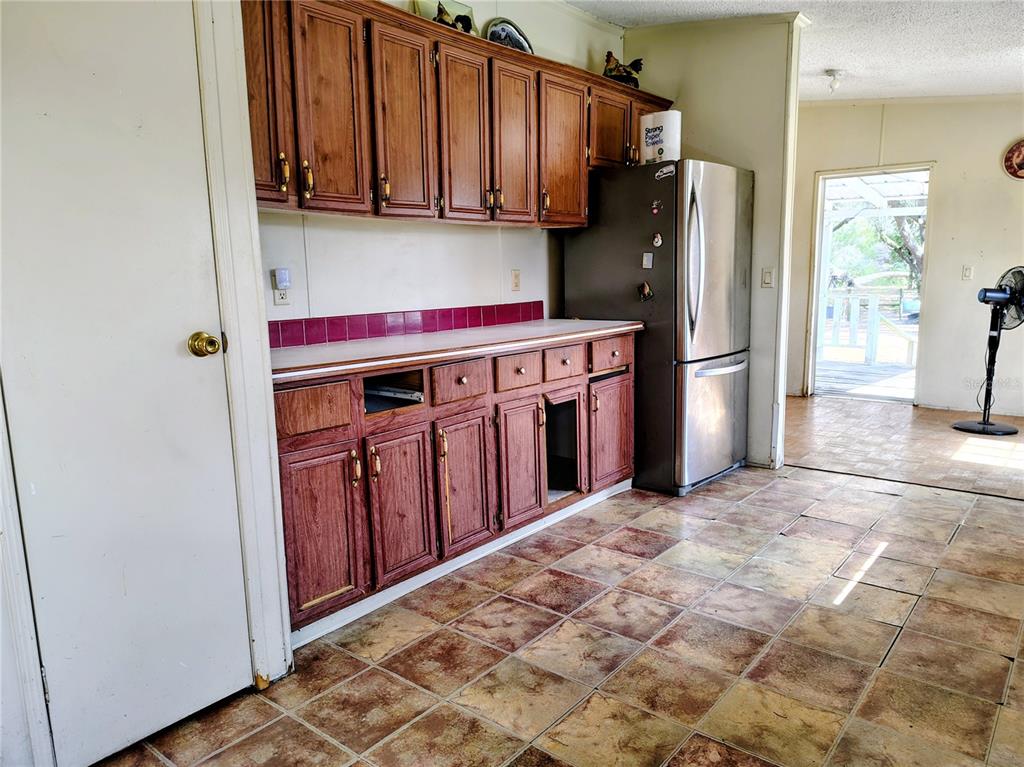 14240 State Rte 471 Webster, FL 33597 - Photo 11 of 54 a kitchen with stainless steel appliances a refrigerator and a sink