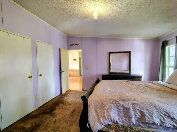 a bedroom with a bed and a television