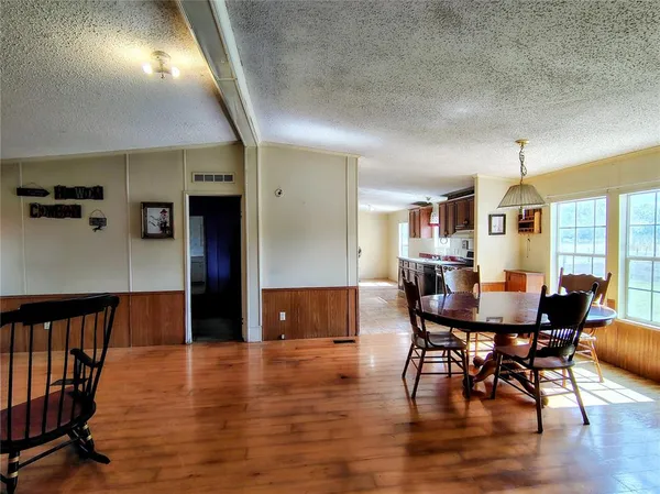 a living room with furniture and a kitchen