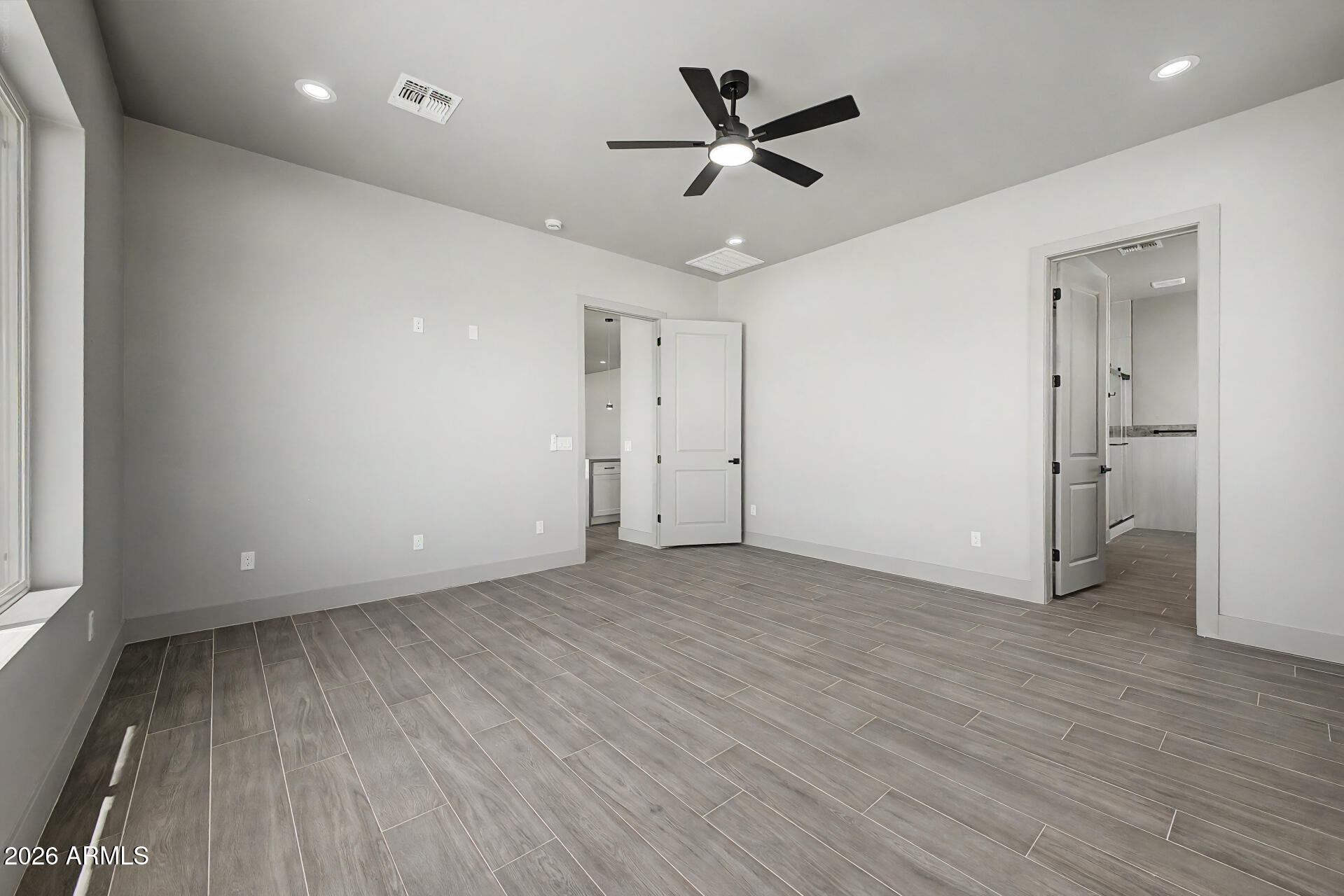 40461 West Robles Road Stanfield, AZ 85172 - Photo 34 of 54 an empty room with wooden floor and a ceiling fan