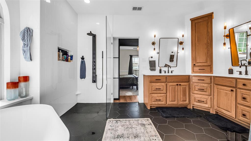 3608 Acropolis Way Plano, TX 75074 - Photo 18 of 37 a bathroom with a double vanity sink a mirror and a shower