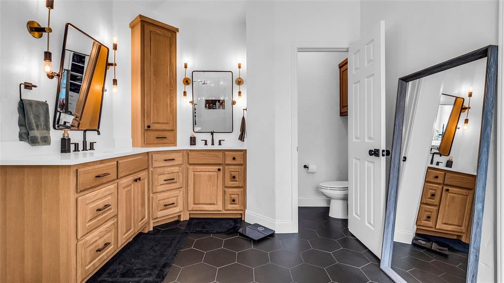 3608 Acropolis Way Plano, TX 75074 - Photo 19 of 37 a spacious bathroom with a double vanity sink a mirror and a toilet