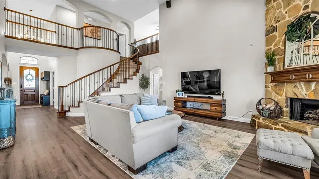 a living room with fireplace furniture and a flat screen tv