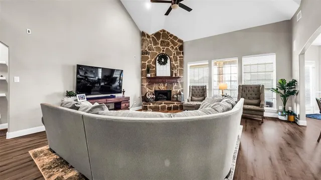 a living room with furniture and a wooden floor