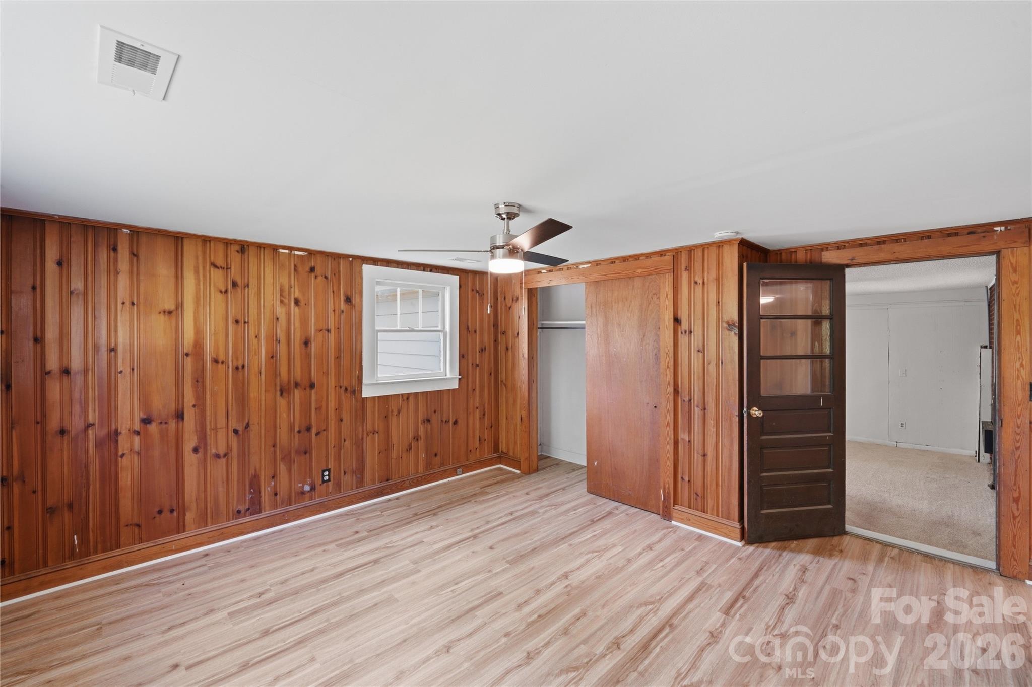 2231 Claremont Road Newton, NC 28658 - Photo 24 of 39 an empty room with wooden floor closet and windows