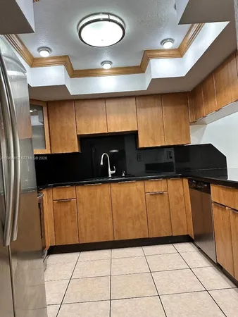 a kitchen with a refrigerator a stove a sink and a microwave