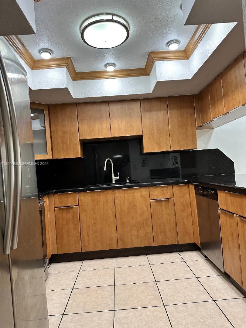 7205 West 3rd Avenue Hialeah, FL 33014 - Photo 1 of 28 a kitchen with a refrigerator a stove a sink and a microwave