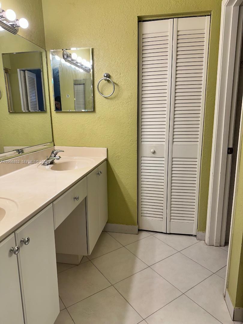 7205 West 3rd Avenue Hialeah, FL 33014 - Photo 16 of 28 a bathroom with a sink and a mirror