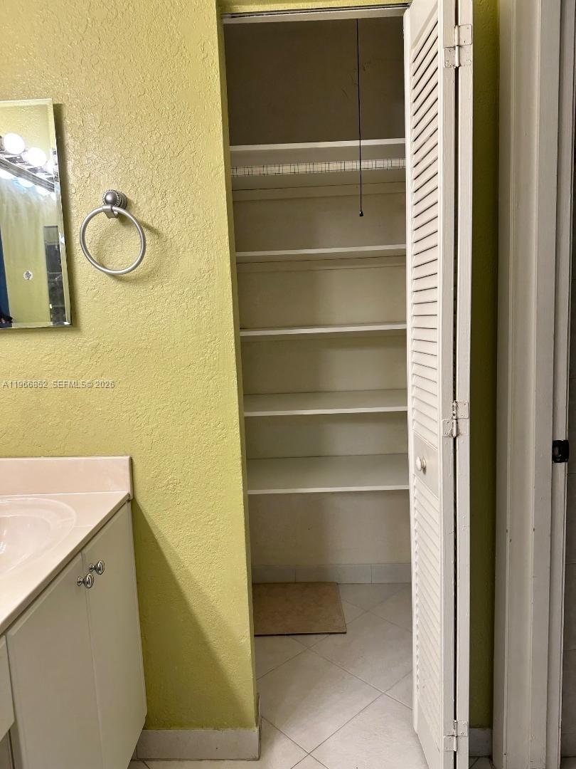 7205 West 3rd Avenue Hialeah, FL 33014 - Photo 18 of 28 a bathroom with a sink and a mirror